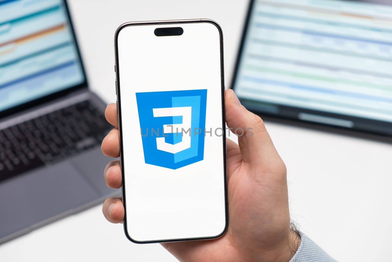 PRAGUE, CZECH REPUBLIC - JANUARY 21 2024: CSS logo on the screen of smartphone in mans hand on the workplace background.