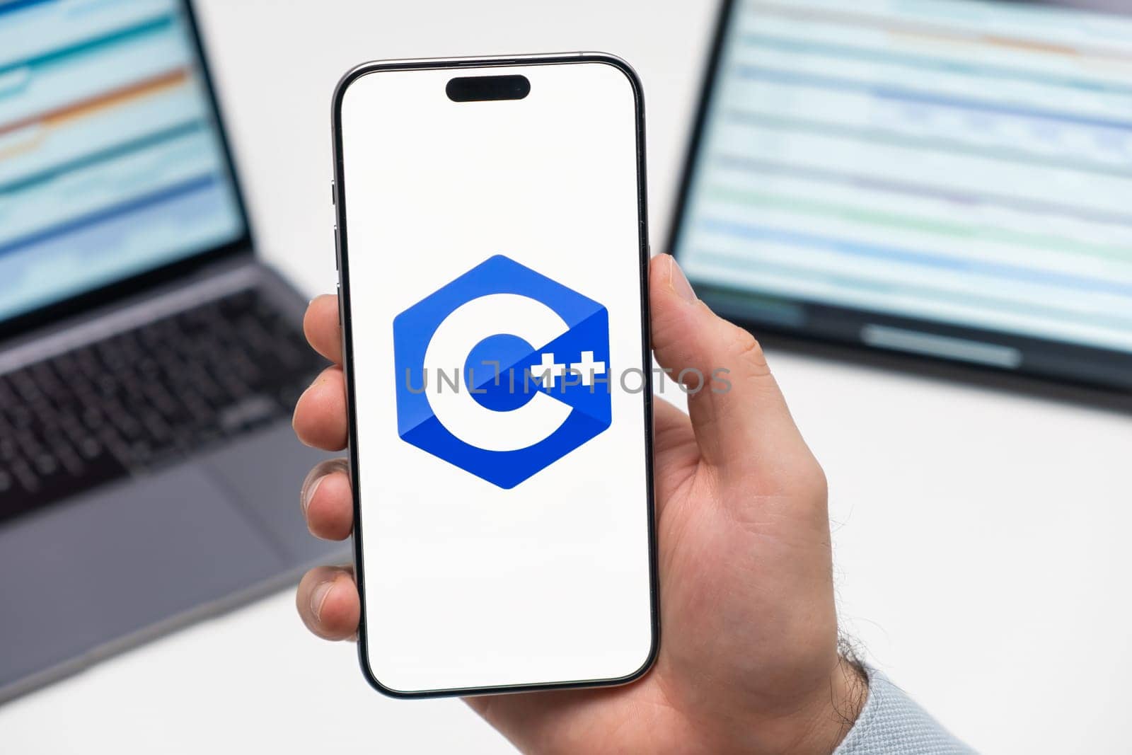 PRAGUE, CZECH REPUBLIC - JANUARY 21 2024: C logo on the screen of smartphone in mans hand on the workplace background.