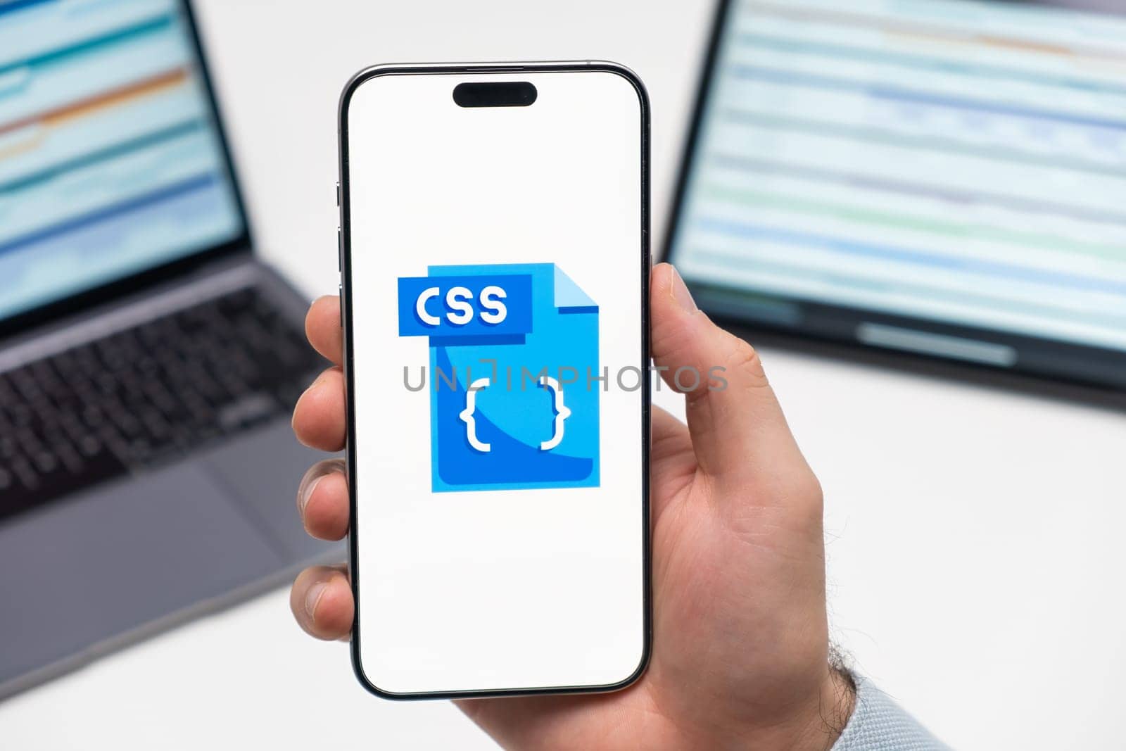 PRAGUE, CZECH REPUBLIC - JANUARY 21 2024: CSS logo on the screen of smartphone in mans hand on the workplace background.