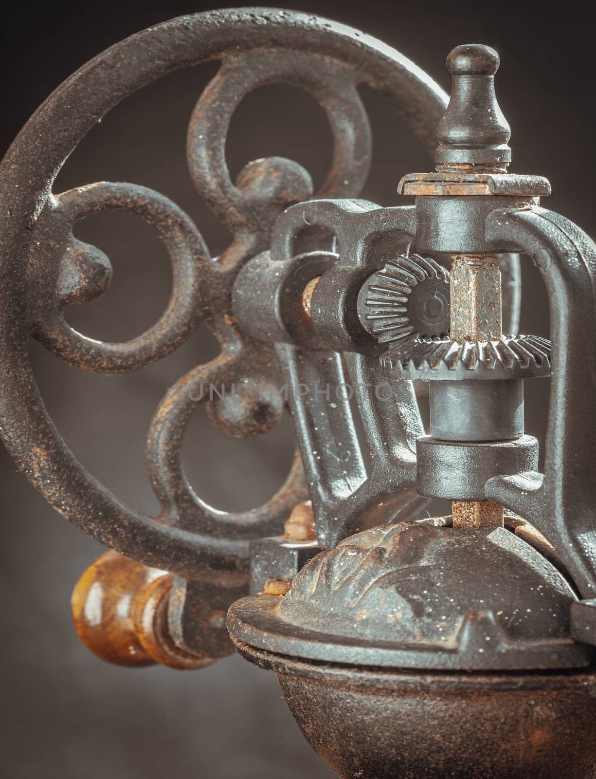 Detail of Antique coffee bean original grinder metal shake wheel with hand crank. by tosirikul