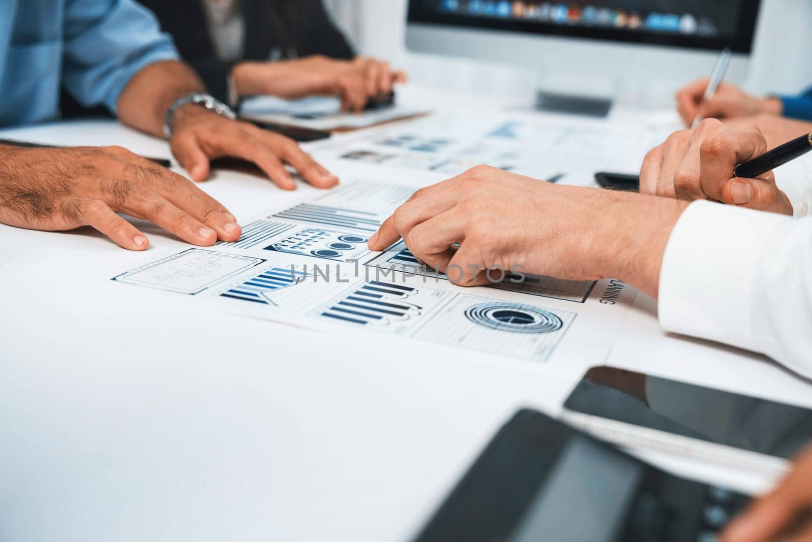 Analyst team utilizing BI Fintech to analyze financial data at table in meeting room. Businesspeople analyzing BI dashboard power on paper for business insight and strategic marketing planning.Prudent