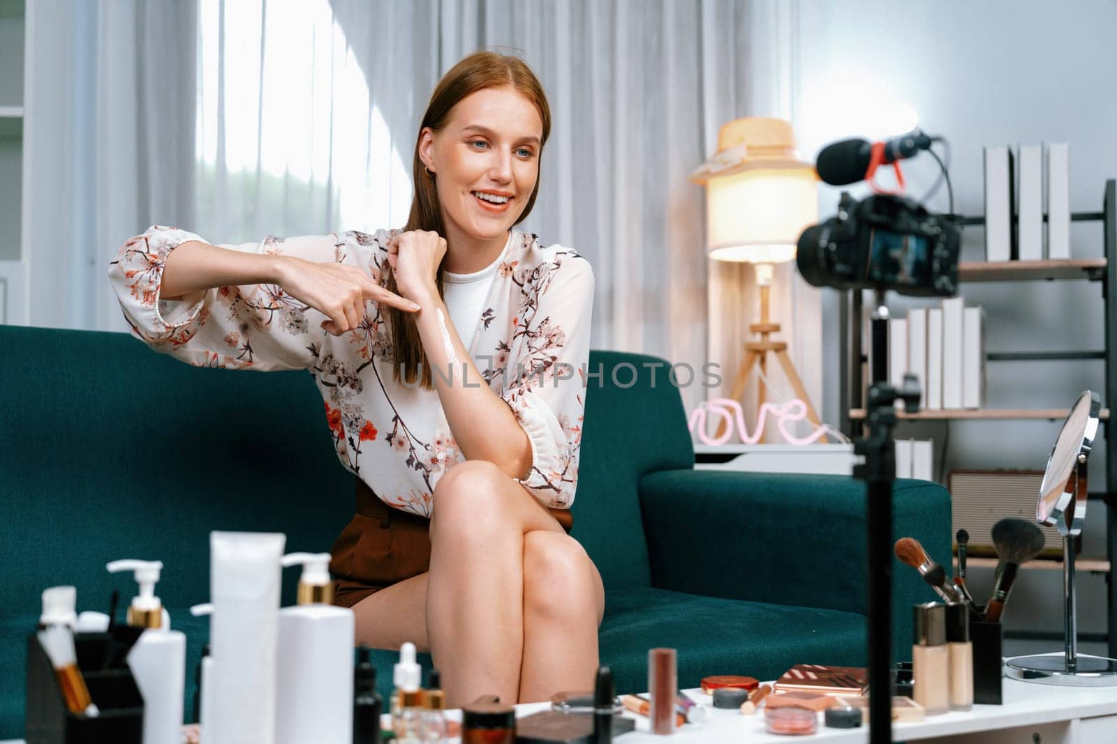 Woman influencer shoot live streaming vlog video review makeup utmost social media or blog. Happy young girl with cosmetics studio lighting for marketing recording session broadcasting online.