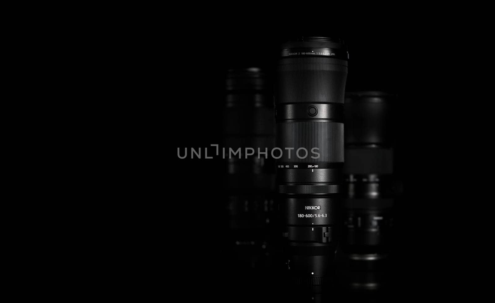 Super telephoto lenses on a black background. The NIKKOR Z 180-600mm f 5.6-6.3 VR in the foreground. Professional photo and video optical lenses for digital camera. 20.02.2024, Yerevan, Armeni by EvgeniyQW