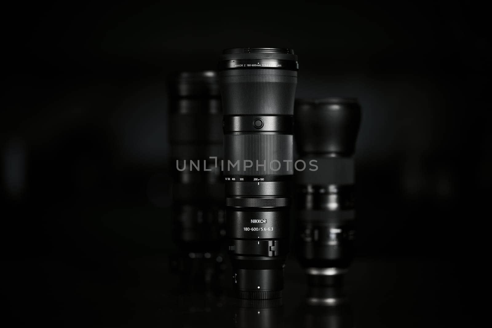 Super telephoto lenses on a blurred background. The NIKKOR Z 180-600mm f 5.6-6.3 VR in the foreground. Professional photo and video optical lenses for digital camera. 20.02.2024, Yerevan, Armenia.