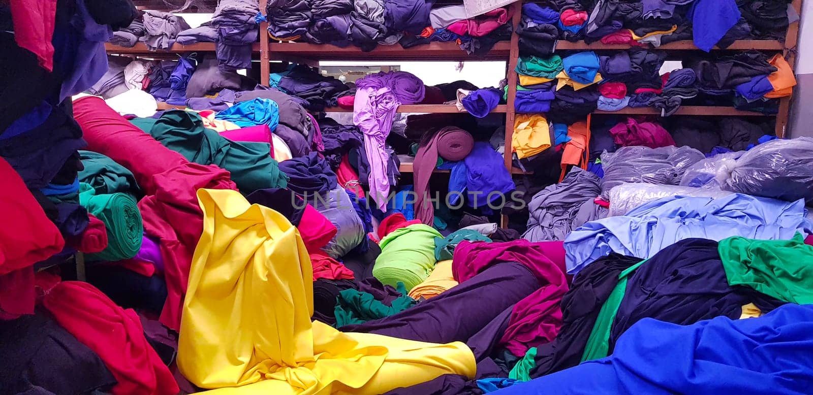 multi colored pile of fabrics, fabric for sewing clothing, fashionable fabric and textile industry