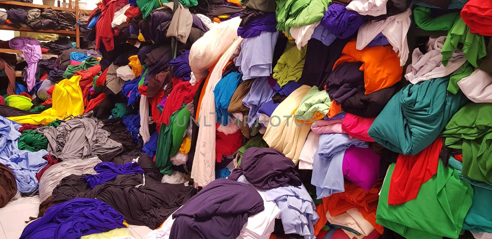 multi colored pile of fabrics, fabric for sewing clothing, fashionable fabric and textile industry