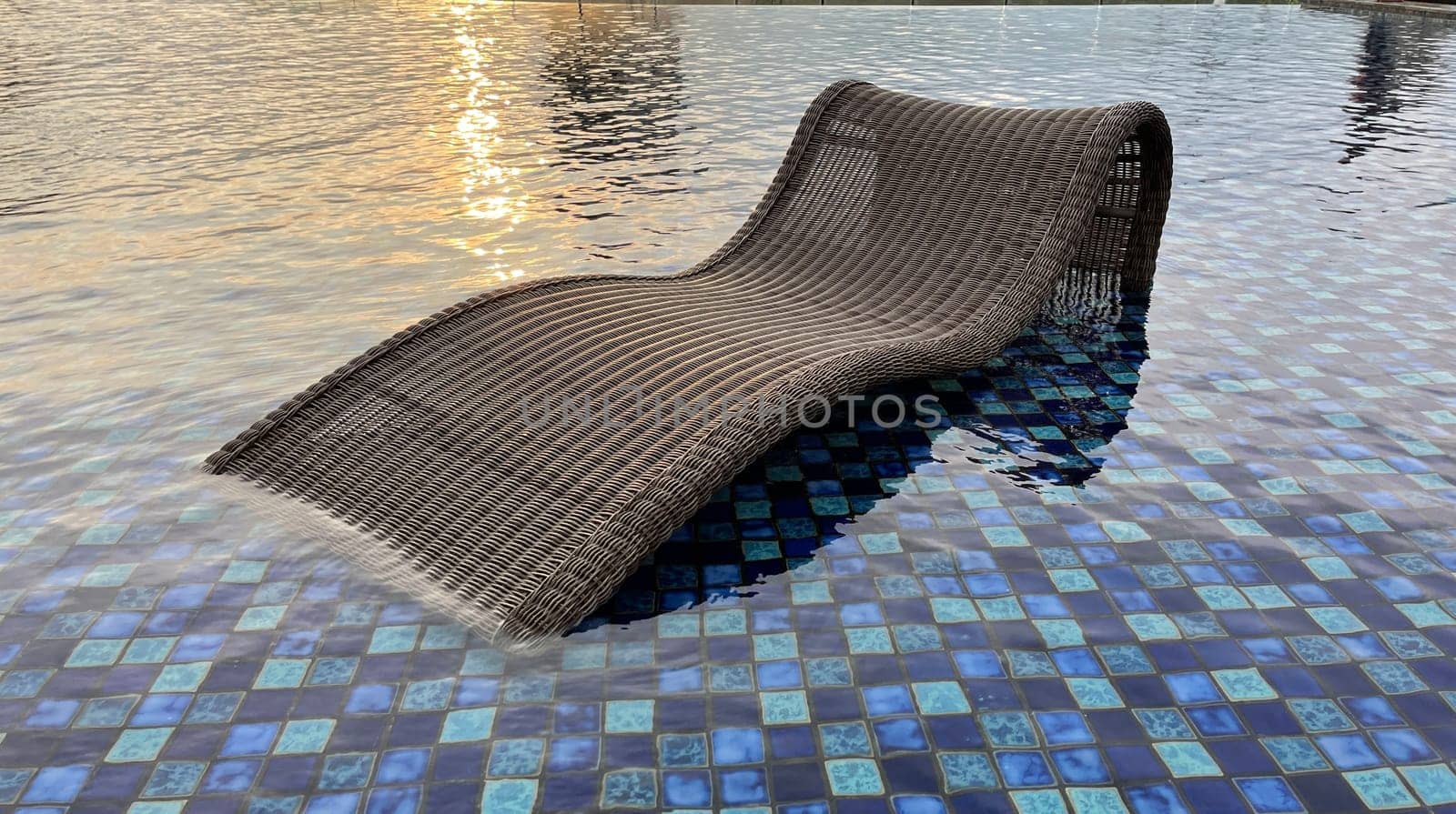 relax deck chair by the blue pool at swimming pool in luxury spa resort or villa Tourism industry crisis after covid 19 coronavirus pandemic Travel lifestyle on family summer vacation