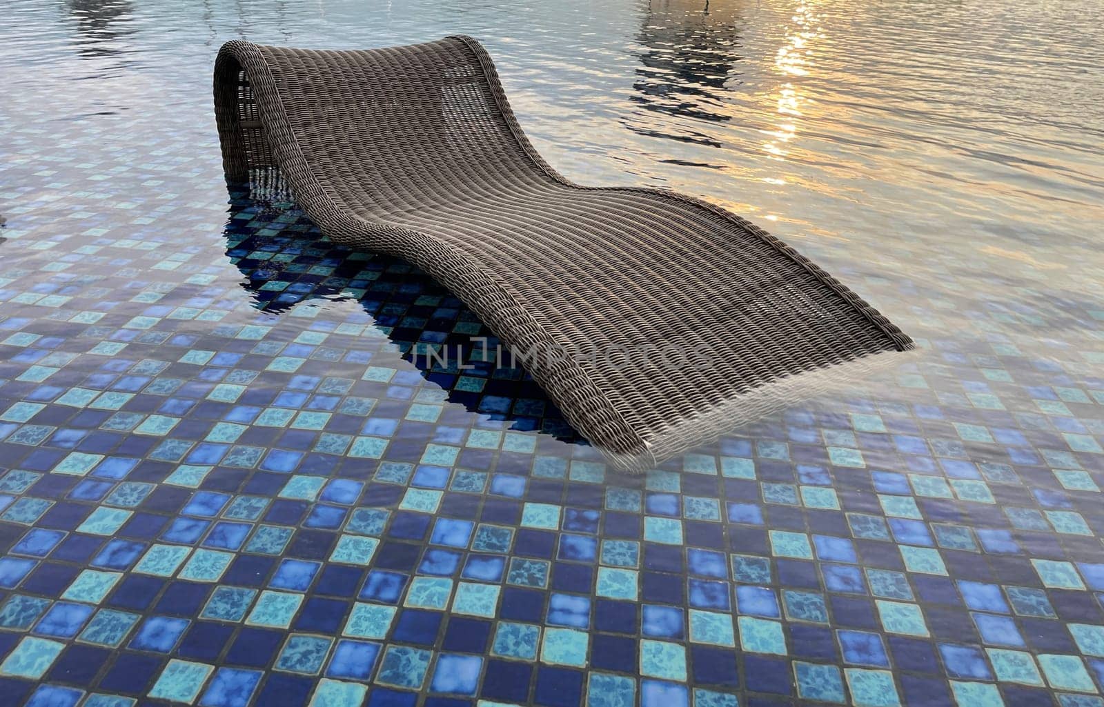 relax deck chair by the blue pool at swimming pool in luxury spa resort or villa Tourism industry crisis after covid 19 coronavirus pandemic Travel lifestyle on family summer vacation