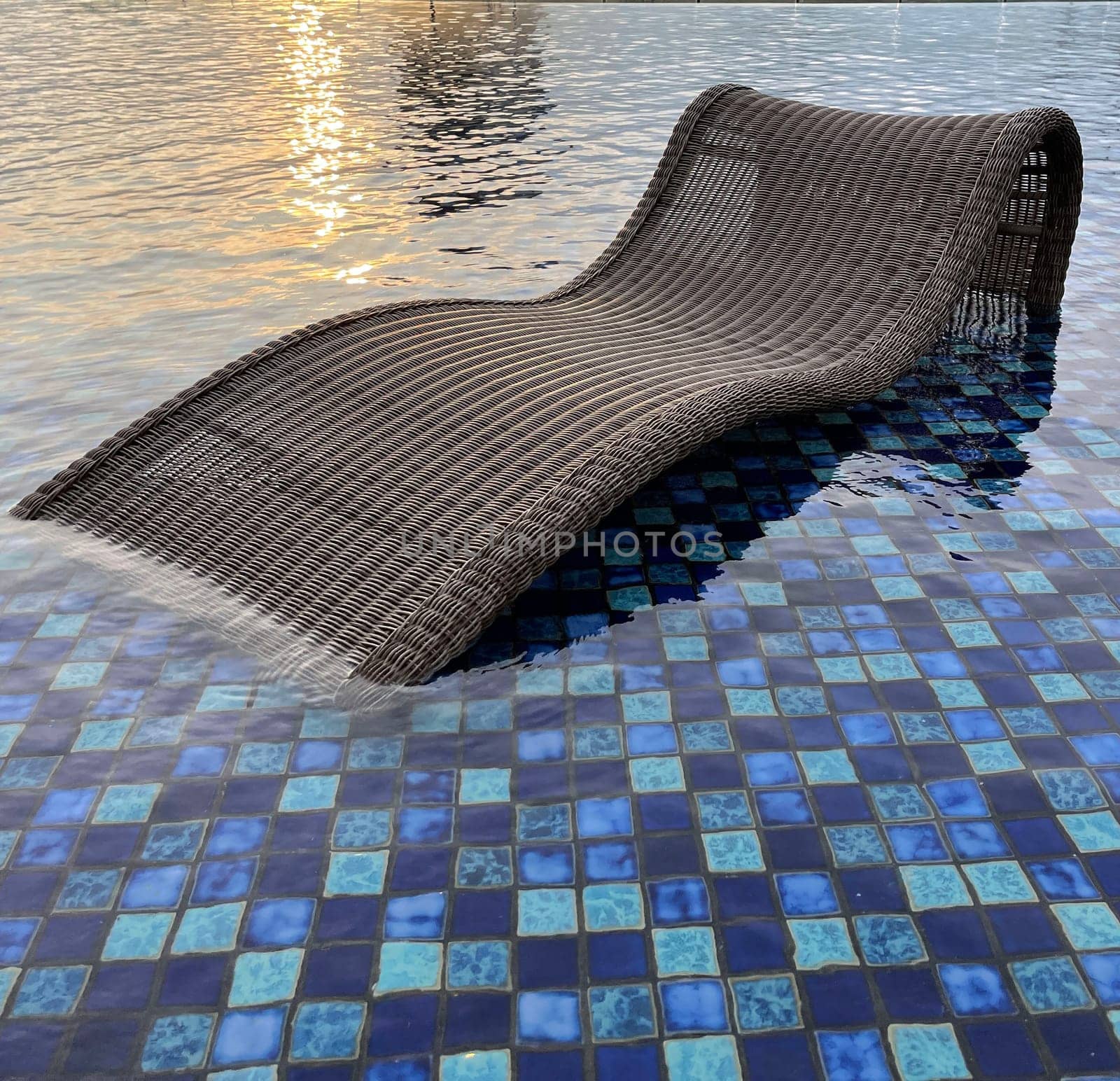 relax deck chair by the blue pool at swimming pool in luxury spa resort or villa Tourism industry crisis after covid 19 coronavirus pandemic Travel lifestyle on family summer vacation