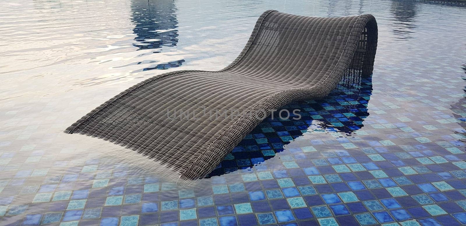 relax deck chair by the blue pool at swimming pool in luxury spa resort or villa Tourism industry crisis after covid 19 coronavirus pandemic Travel lifestyle on family summer vacation