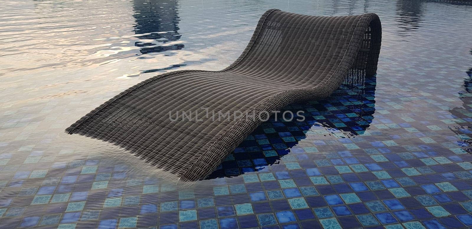 relax deck chair by the blue pool at swimming pool in luxury spa resort or villa Tourism industry crisis after covid 19 coronavirus pandemic Travel lifestyle on family summer vacation