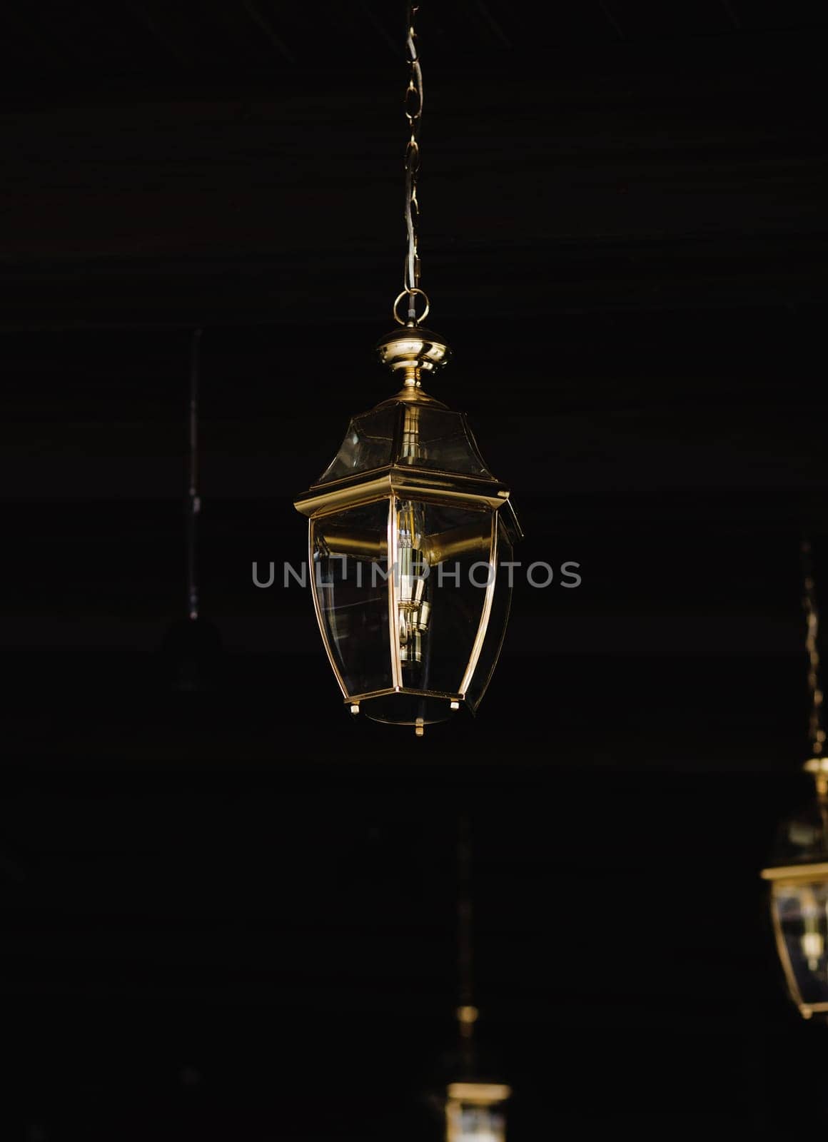 Royal gold decoration lamp against dark wall.
