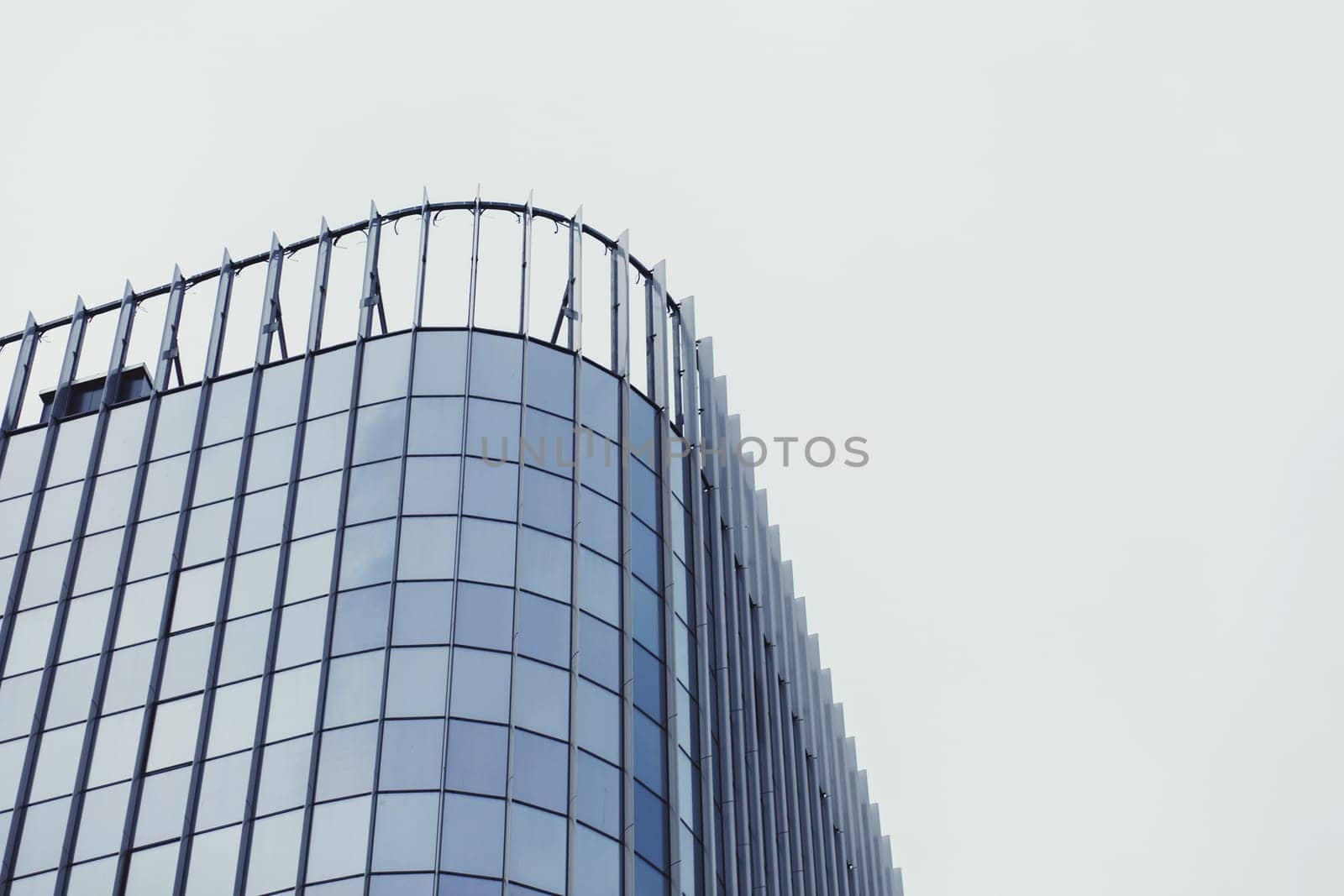 Glass modern office building on sky background