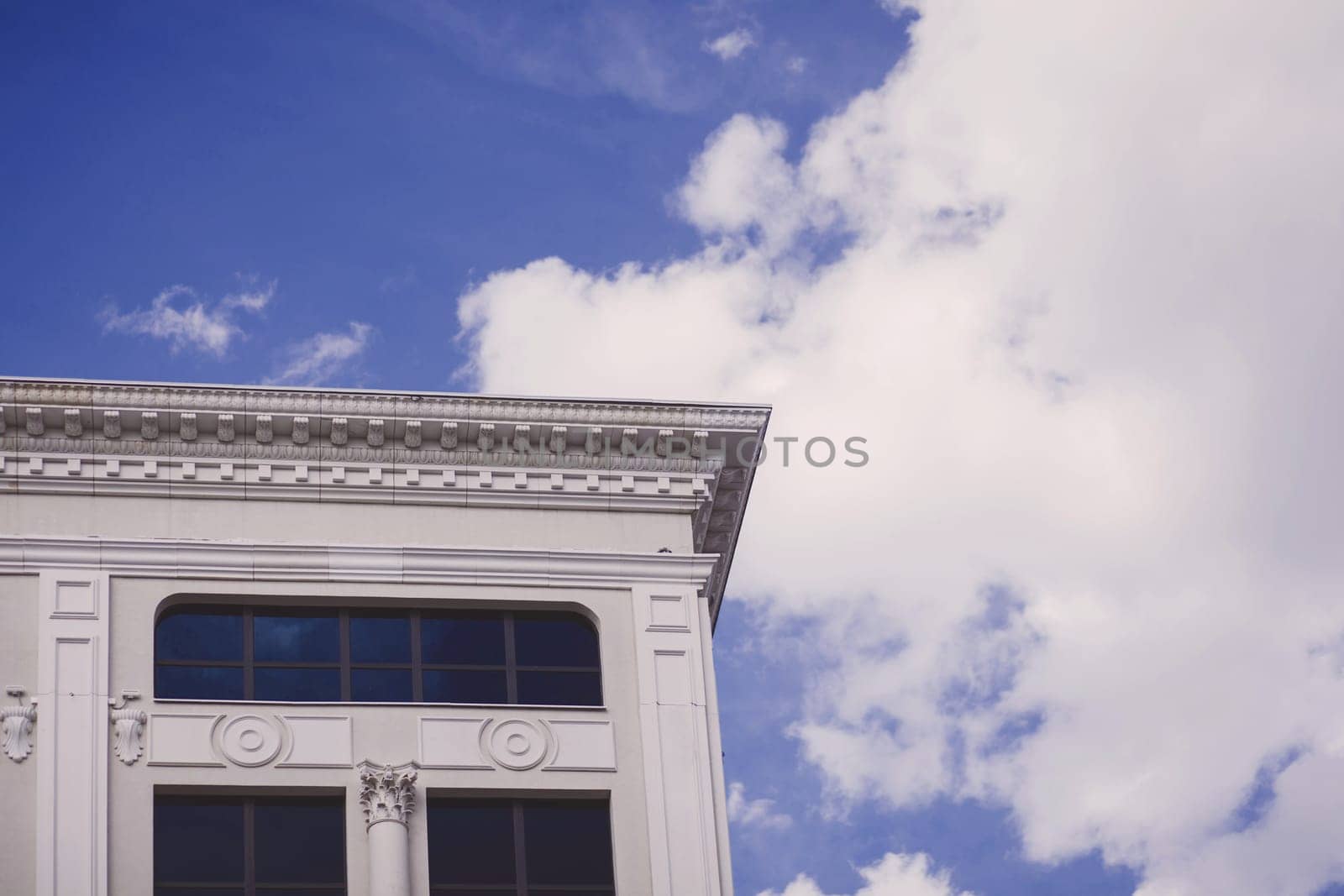 modern building with imitation of antique style on sky background