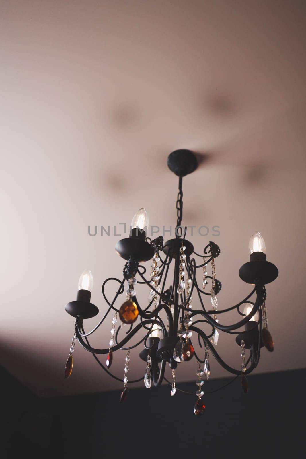 old classic chandelier hanging on the ceiling of the hotel