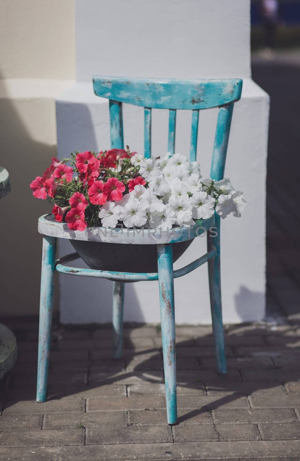 Outdoor restaurant beautifully decorated with plants by Ladouski