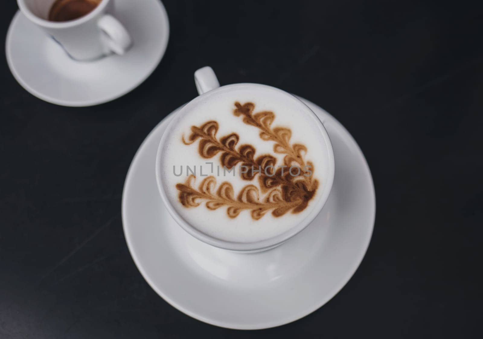 two mugs of coffee on the table. cappuccino with milk foam and espresso