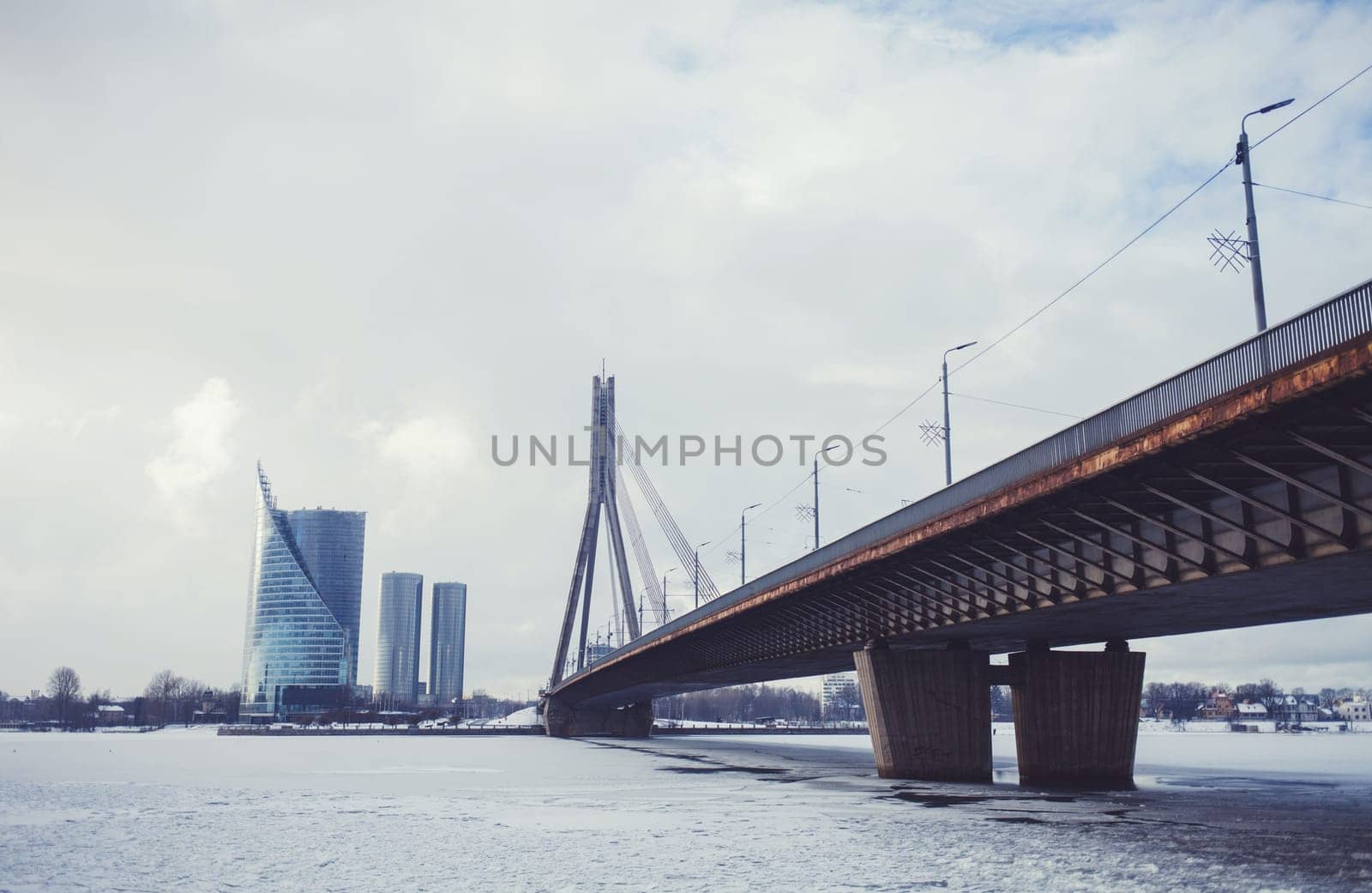 Bridge across the winter Daugava river in Riga, Latvia