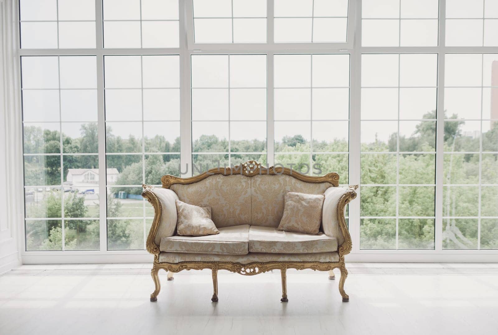 luxury interior of the living room and bedroom in light colors with  chic carved furniture in classic style
