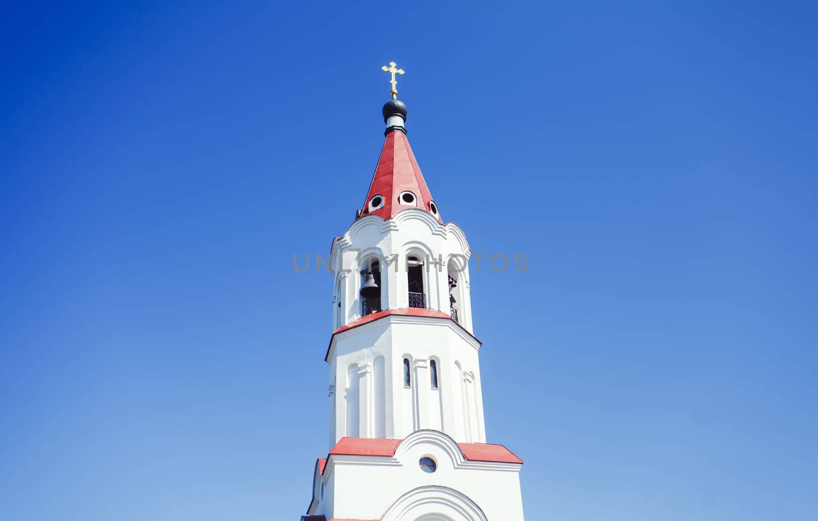 Church building with a cross against the blue sky