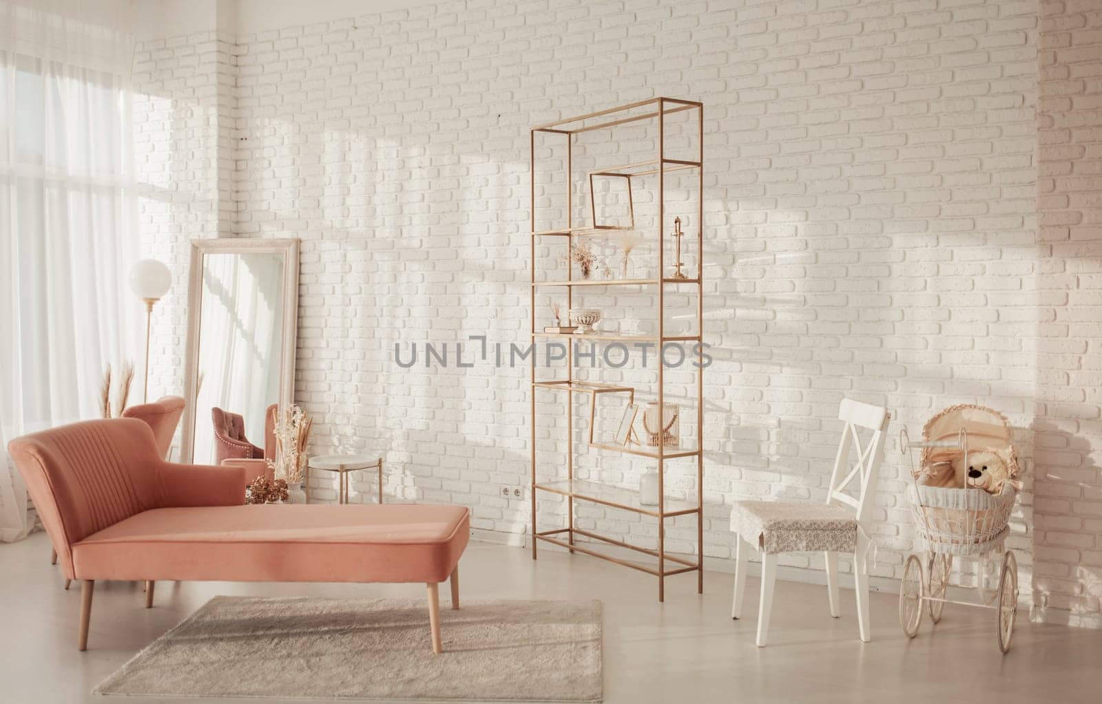 Spacious white room with carpet, sofa, mirror and armchair
