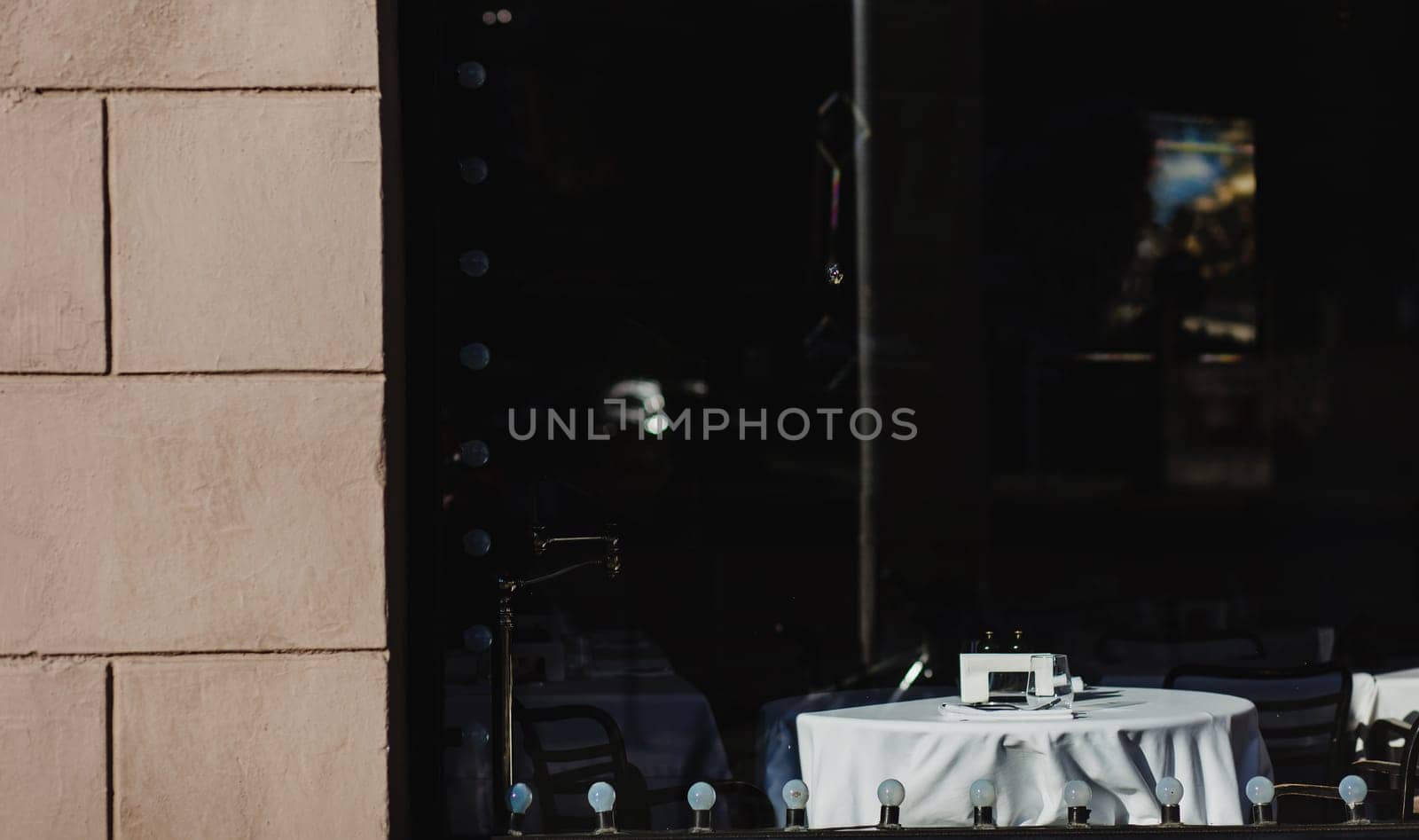 Window of an old bistro with empty tables in Europe