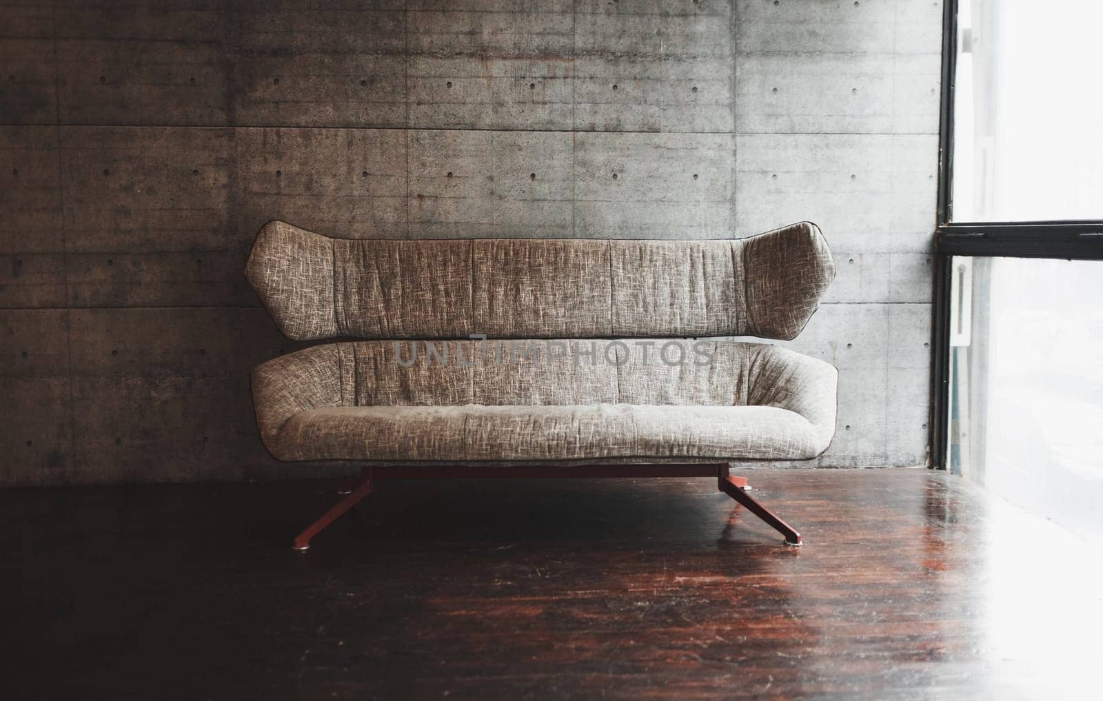 stylish spare room with sofa and large window in loft style