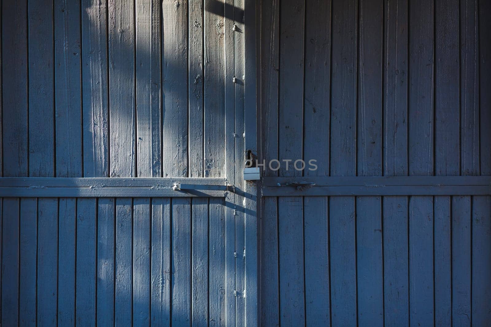 old wooden gate with metal lock