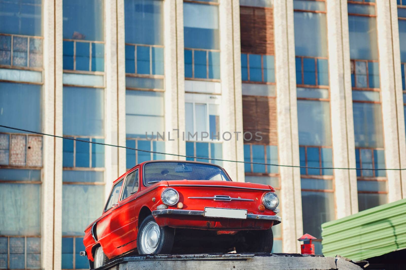 Minsk, Belarus - August  2019. Colorful red soviet retro car near old building. 