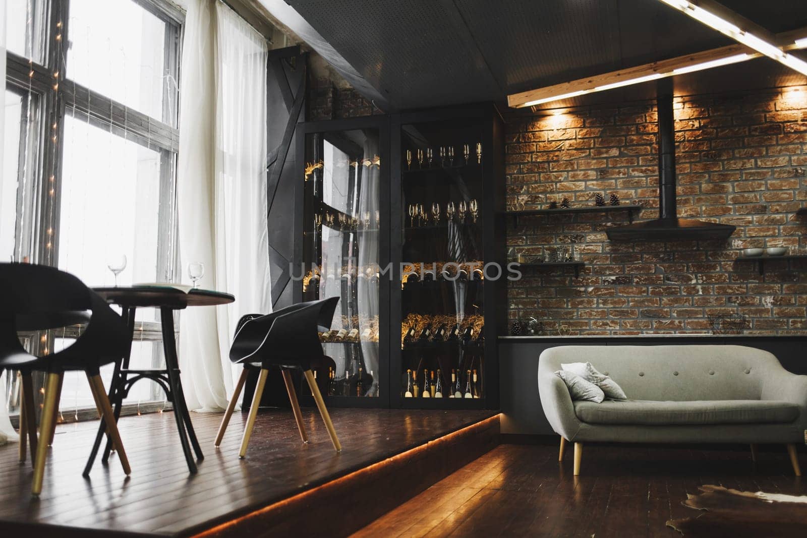 Spacious living room with sofa and dining table. loft interior