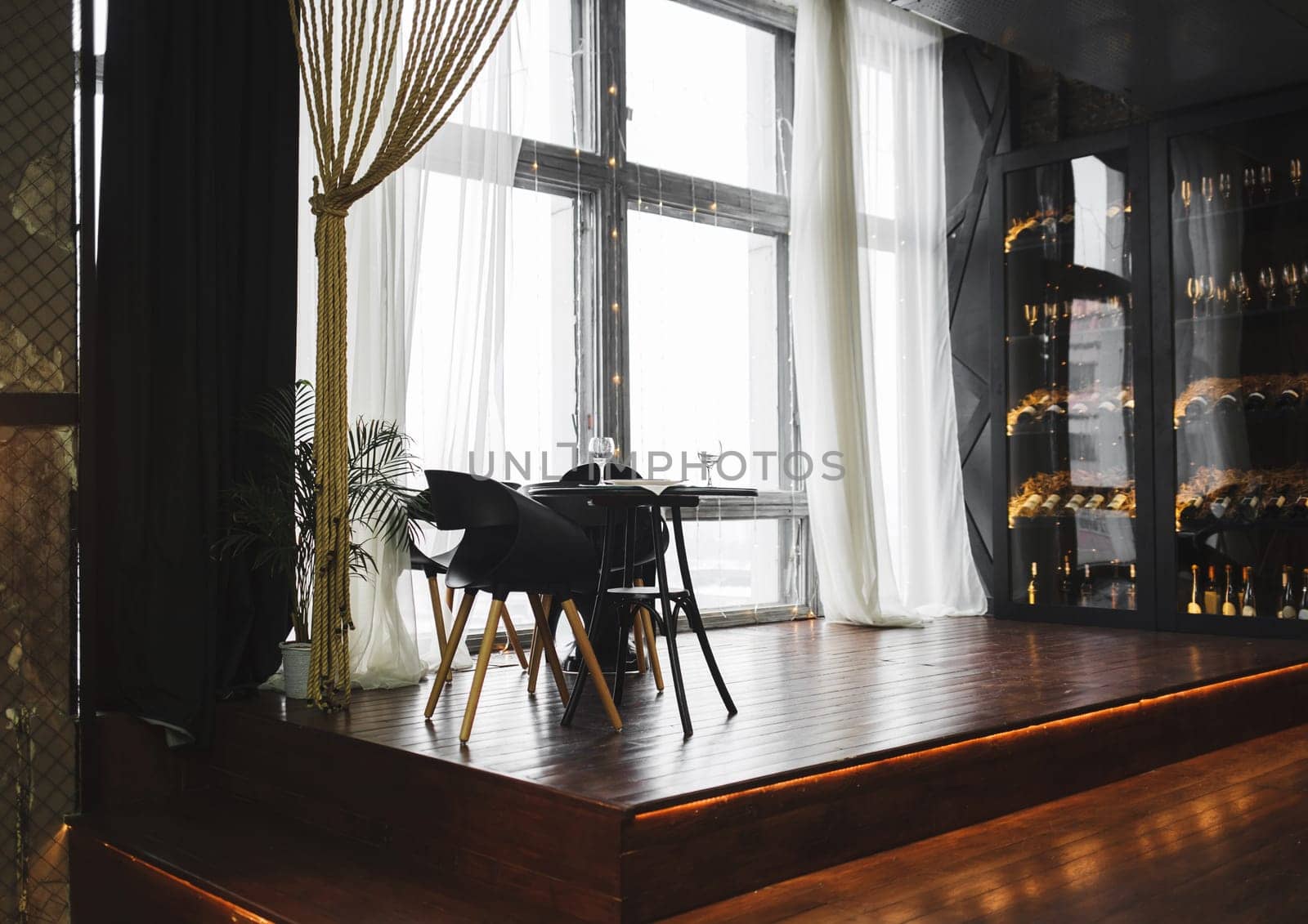 Modern minimalistic dark loft style studio apartment interior design. Sitting area, workplace