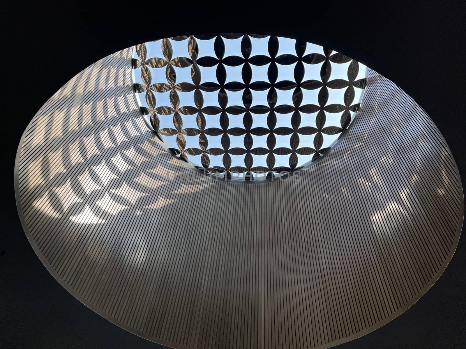 Interesting and unique artistic building roof pattern and texture for backgrounds against blue sky