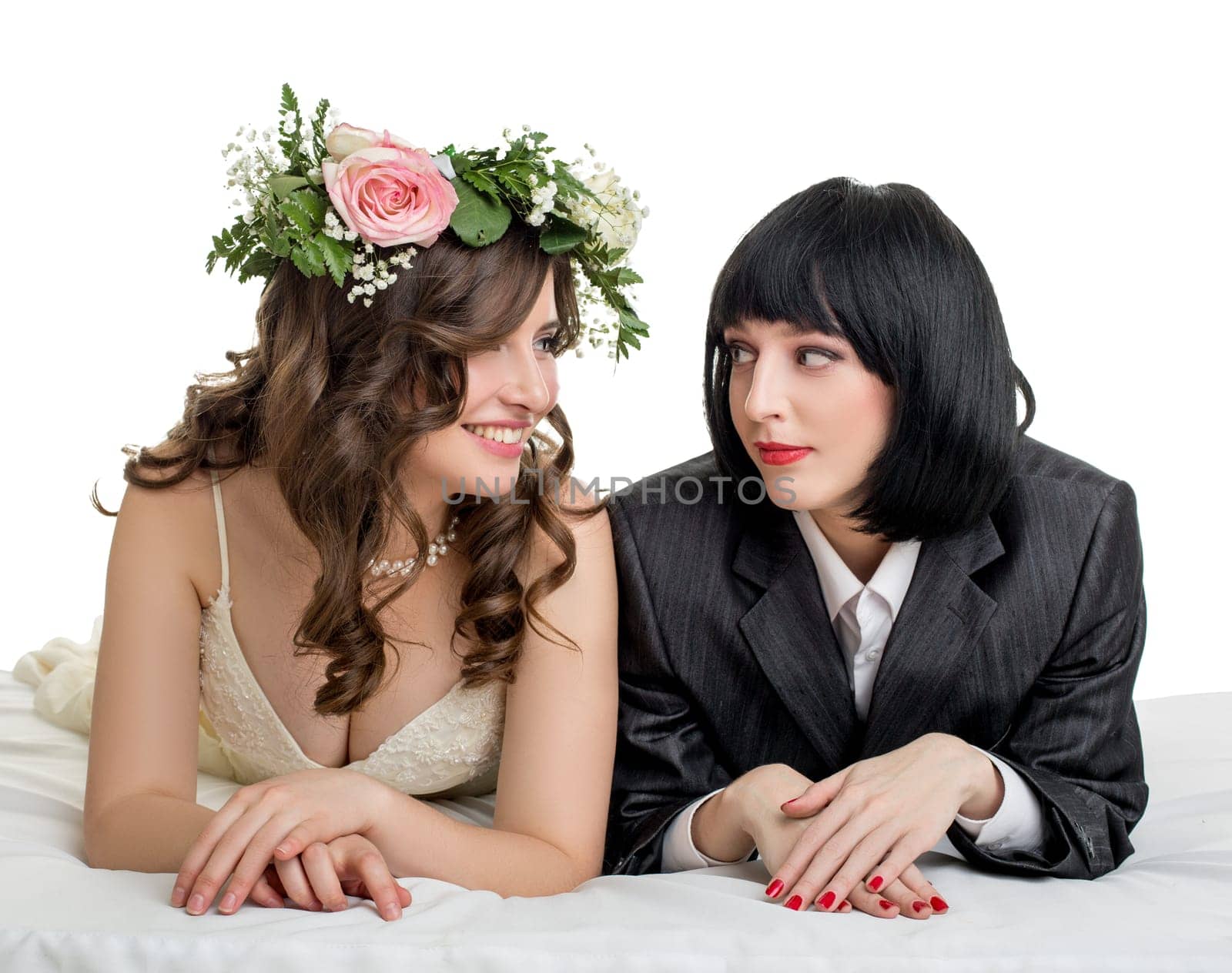 Same-sex marriage. Studio photo of girls dressed as bride and groom