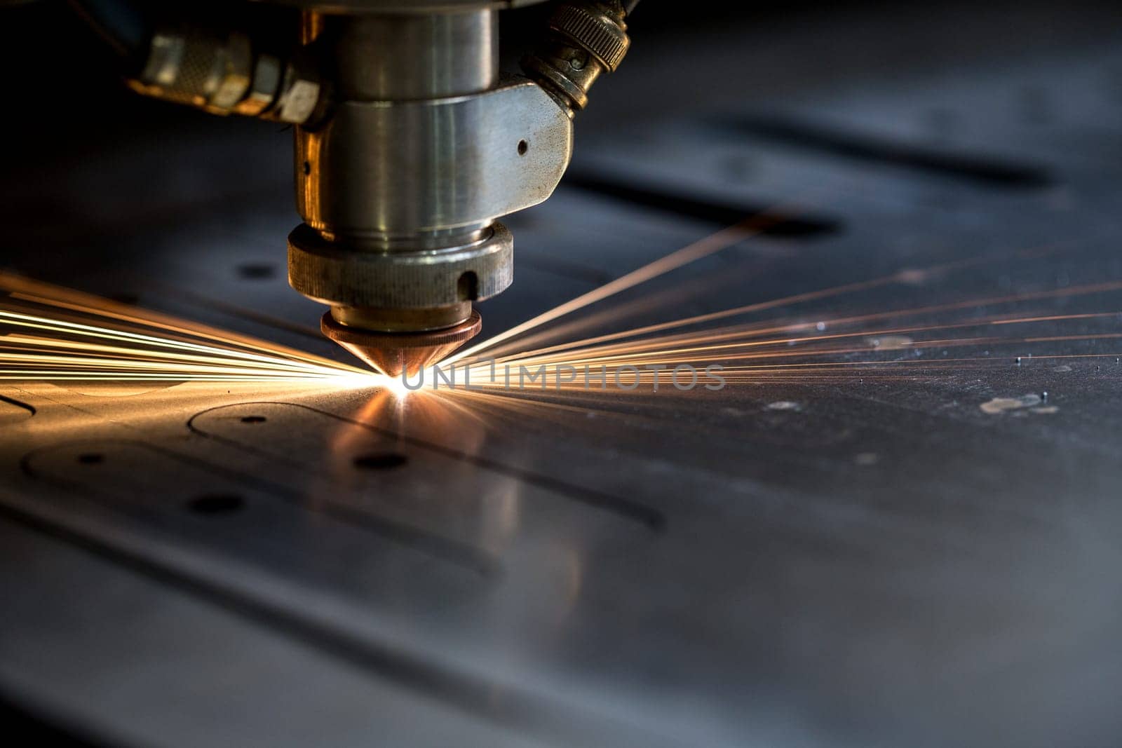 Cutting of metal. Sparks fly from laser, close-up