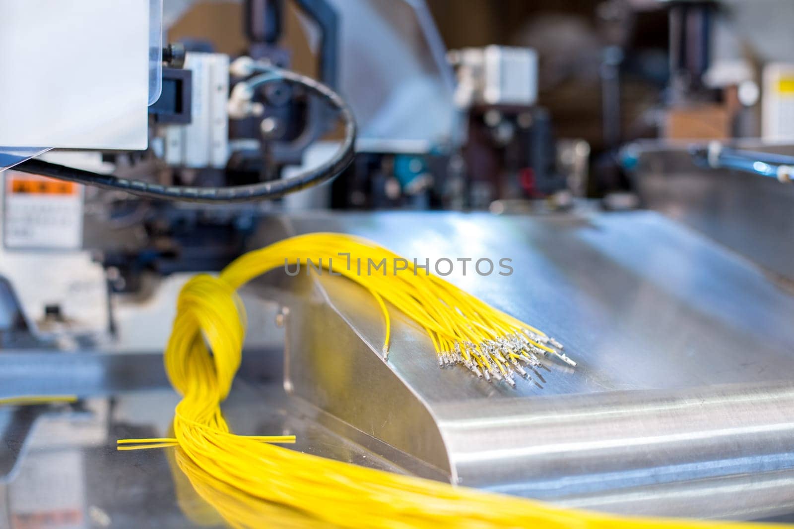 Image of bright crimped wires on machine, close-up