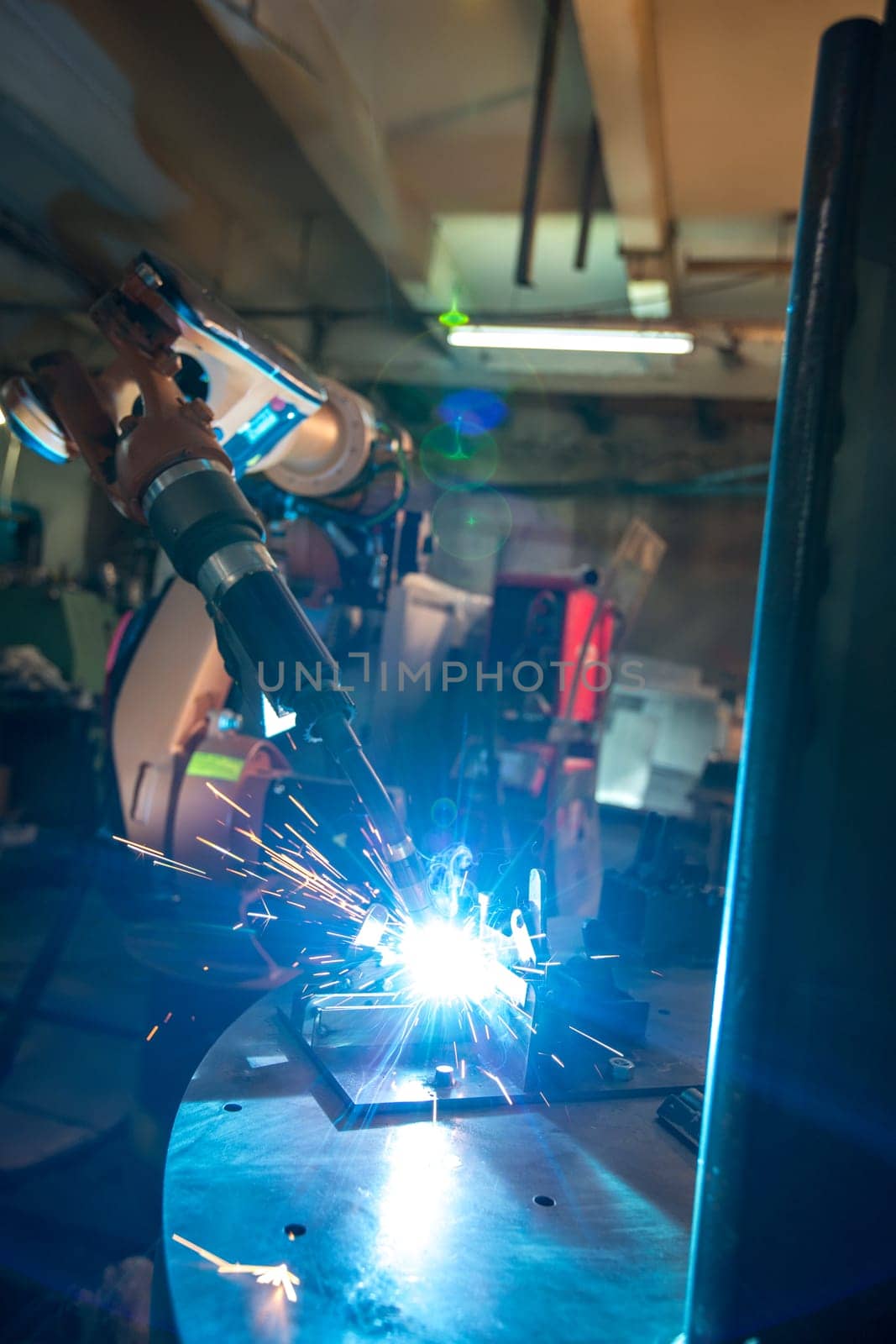 Image of robotic machine welding metal fasteners, close-up