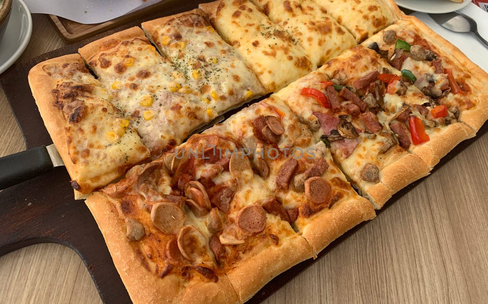 Homemade square pizza with cheese on wooden table Square pizza - Four seasons - Organic pizza - Vegan healthy pizza - Vegetables pizza