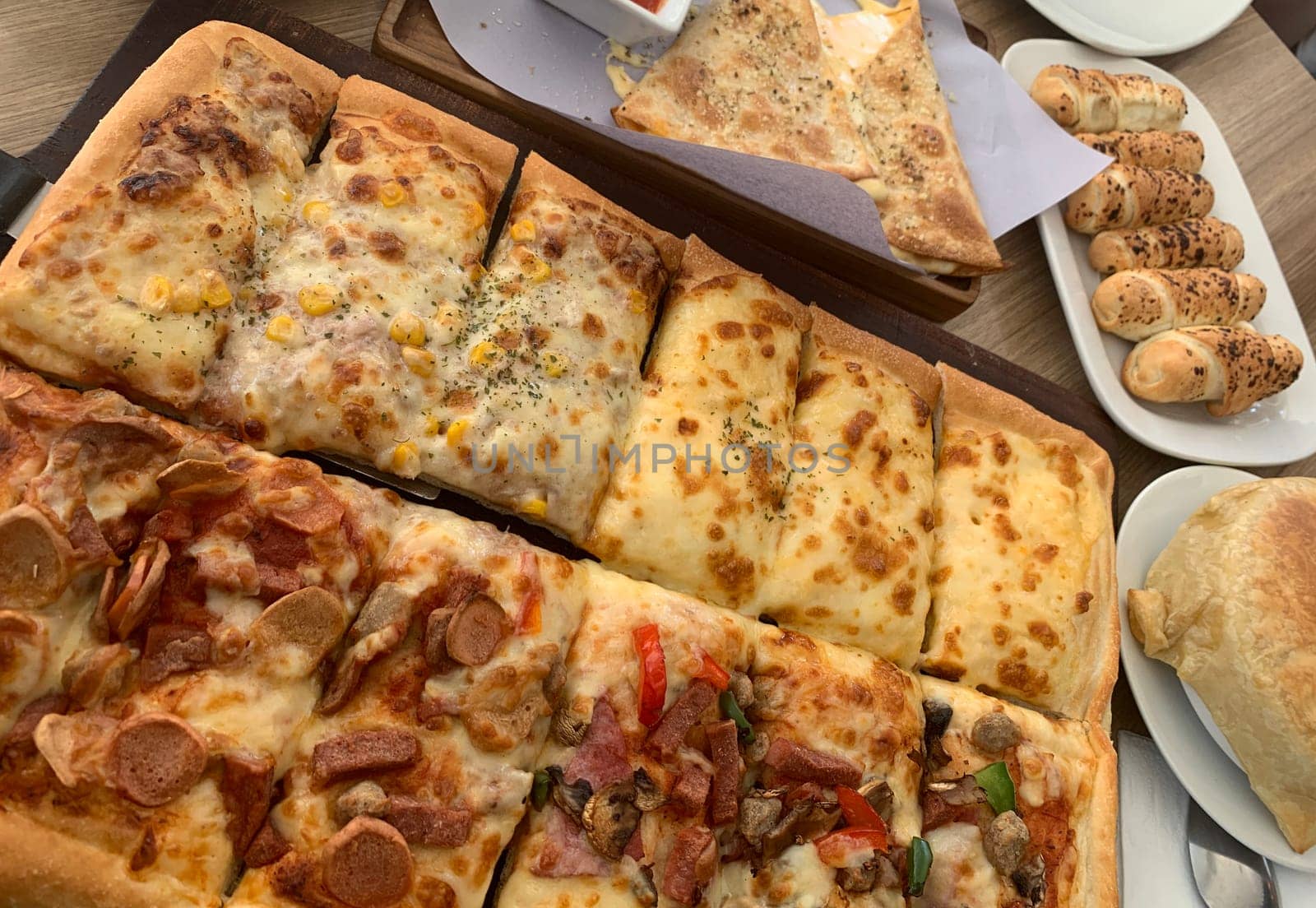 Homemade square pizza with cheese on wooden table Square pizza - Four seasons - Organic pizza - Vegan healthy pizza - Vegetables pizza