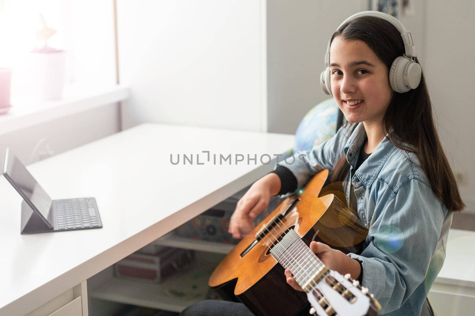 girl giving online guitar lessons, concept study from home online. High quality photo