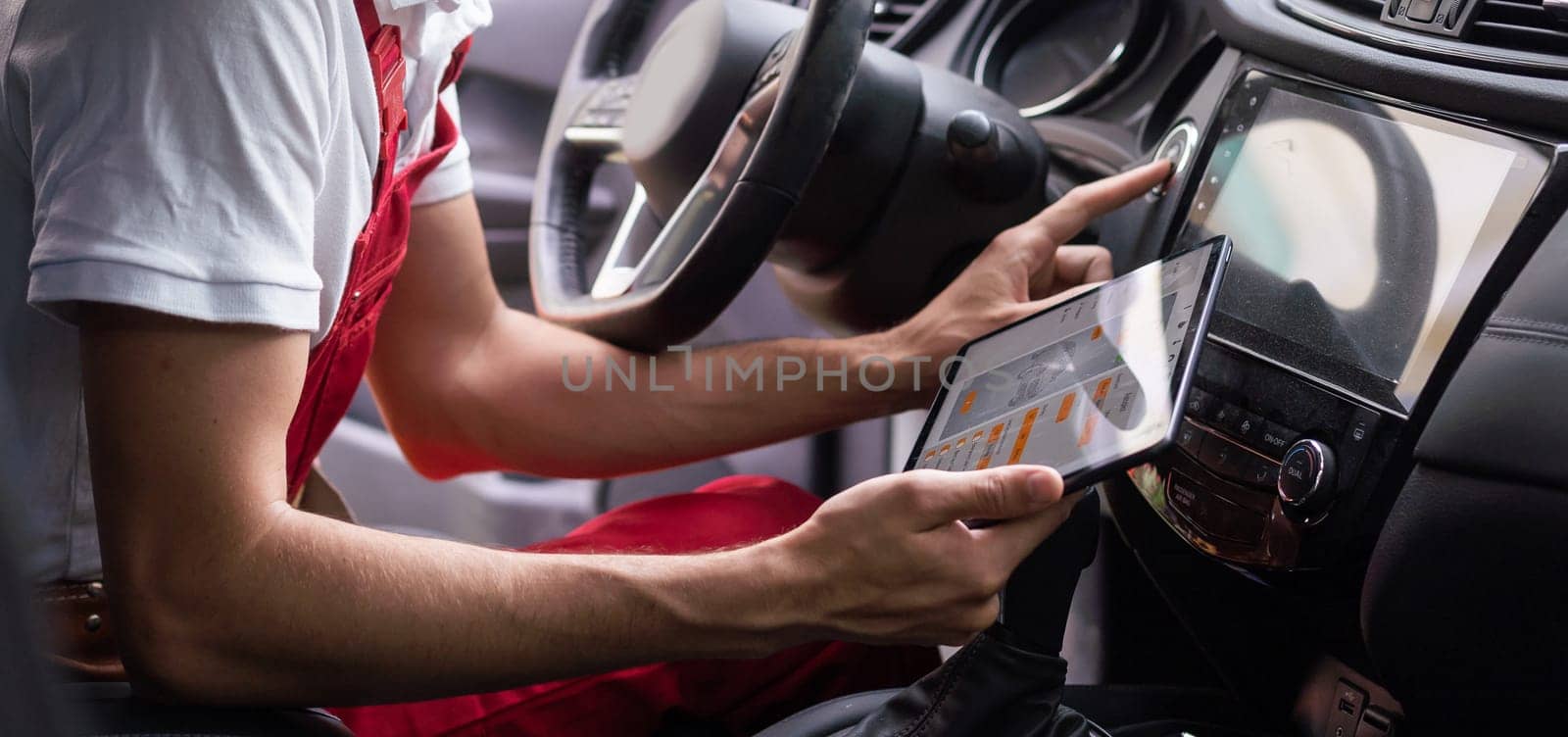 Close-up Of A Car Mechanic Using Digital Tablet