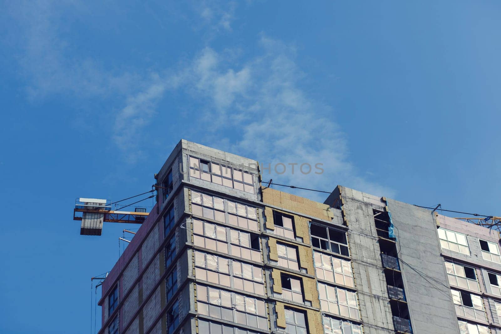 construction site with crane against the blue sky
