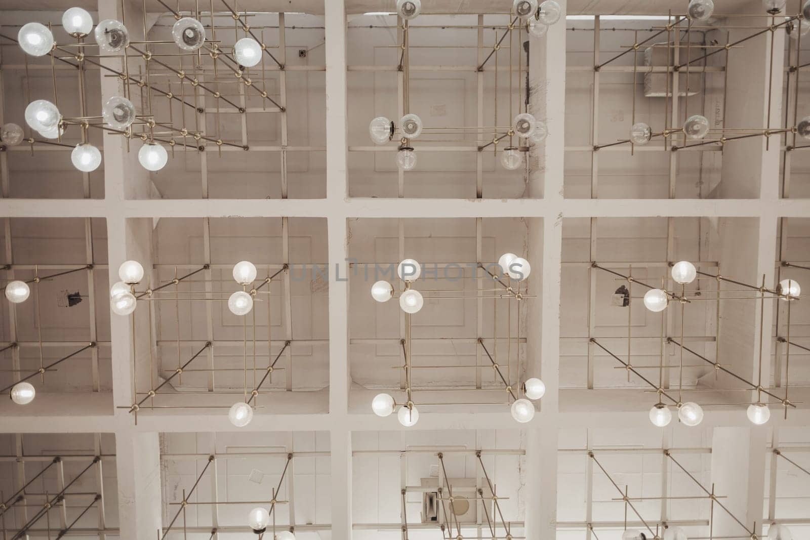 many light bulbs on the ceiling of the office space