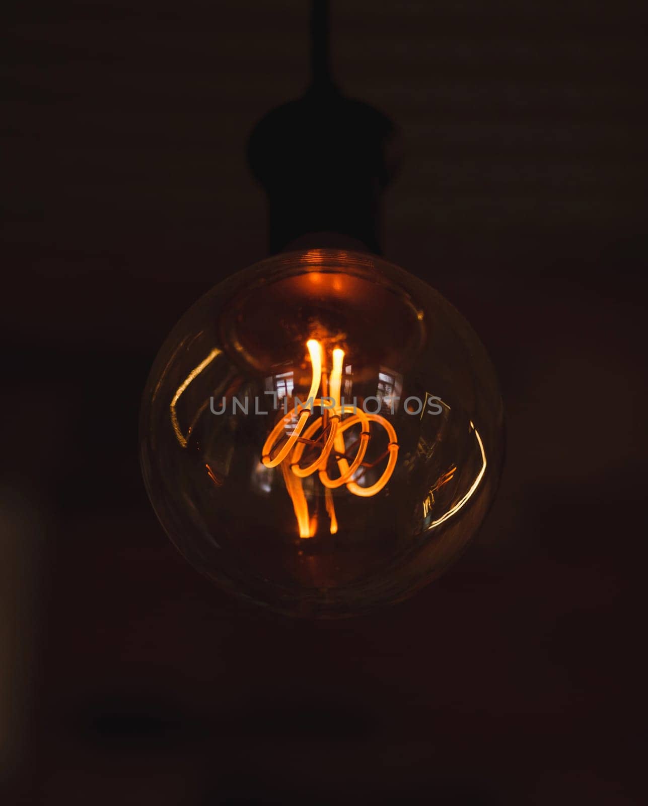 Vintage hanging light bulb over dark background