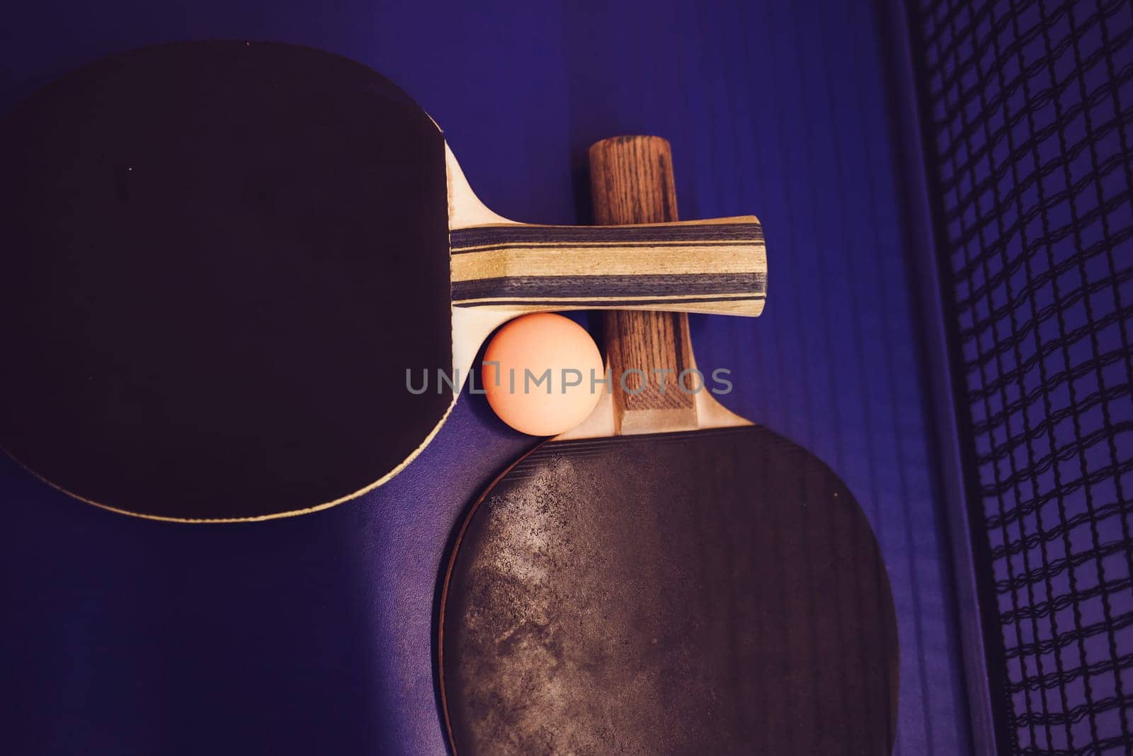 ping-pong rackets and ball on blue background. Sport concept.