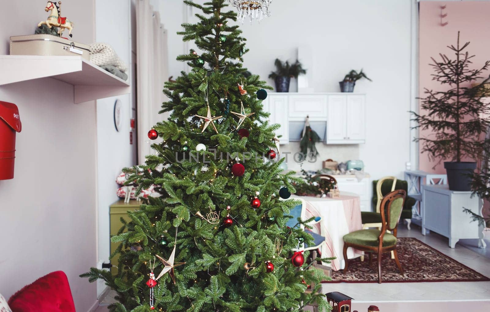 the classic interior of the living room is decorated with a chic Christmas tree, gifts
