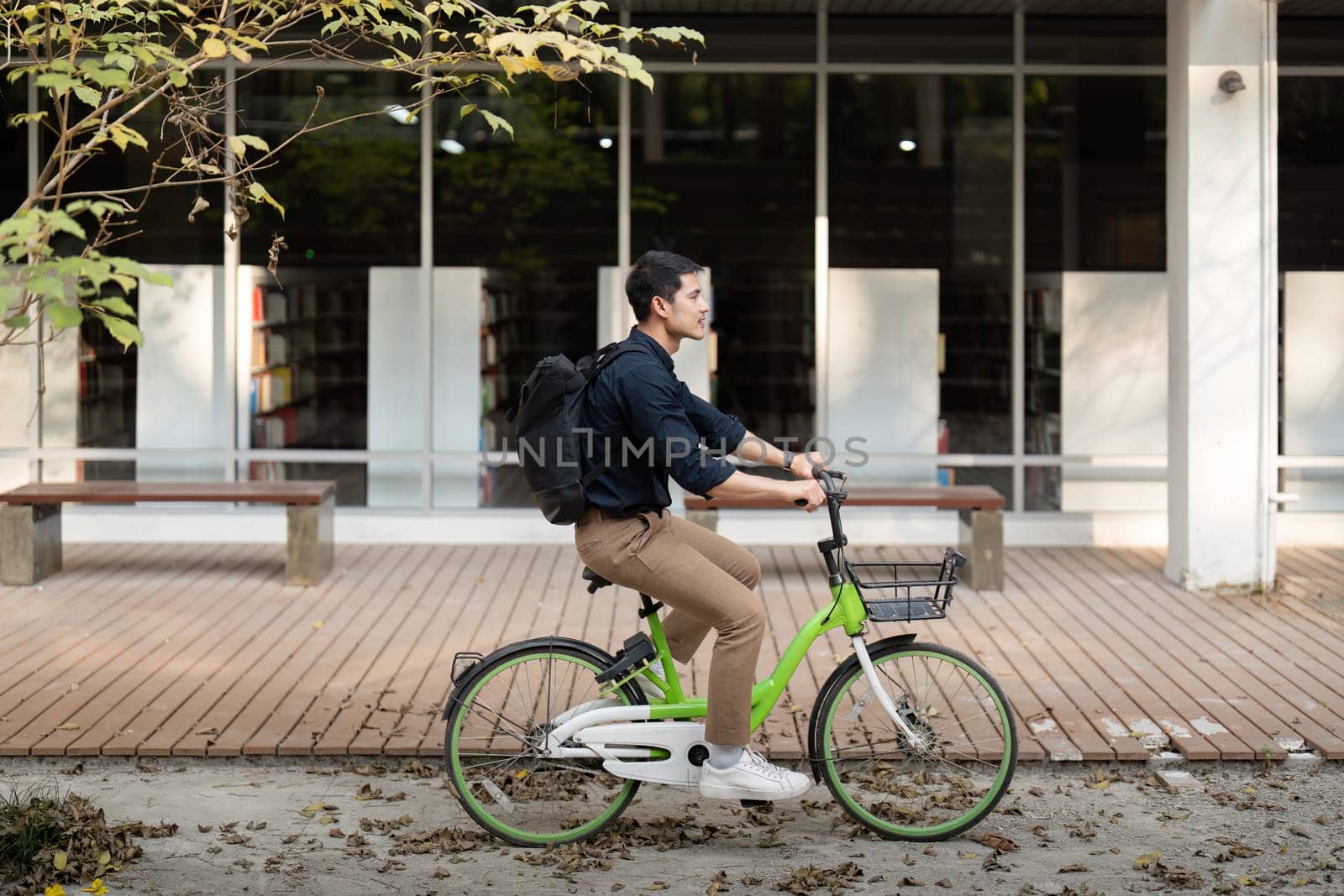 Businessman and bicycle in city to work with eco friendly transport. happy businessman professional riding a bicycle in urban street.