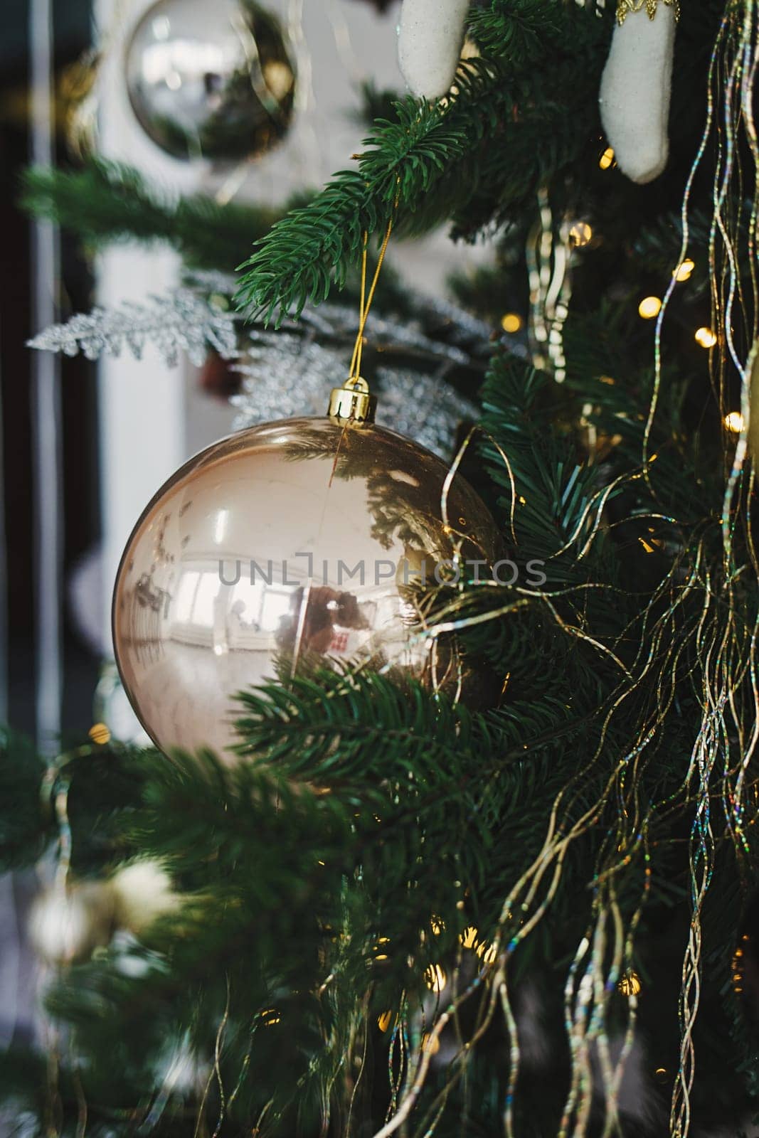 Shiny christmas ball hanging on pine branches 
