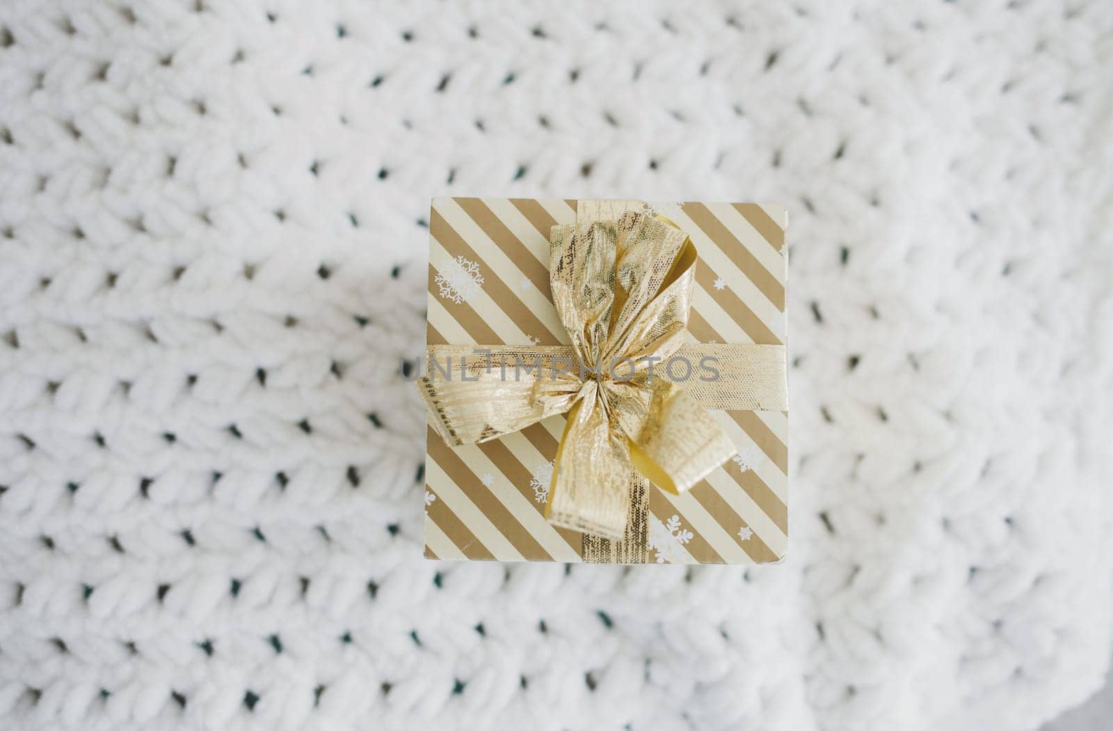 Christmas gift box on wool  background, preparation for holidays