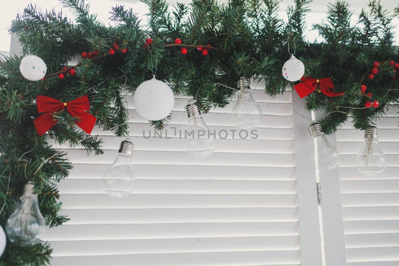 Christmas decoration with red ribbons on the window