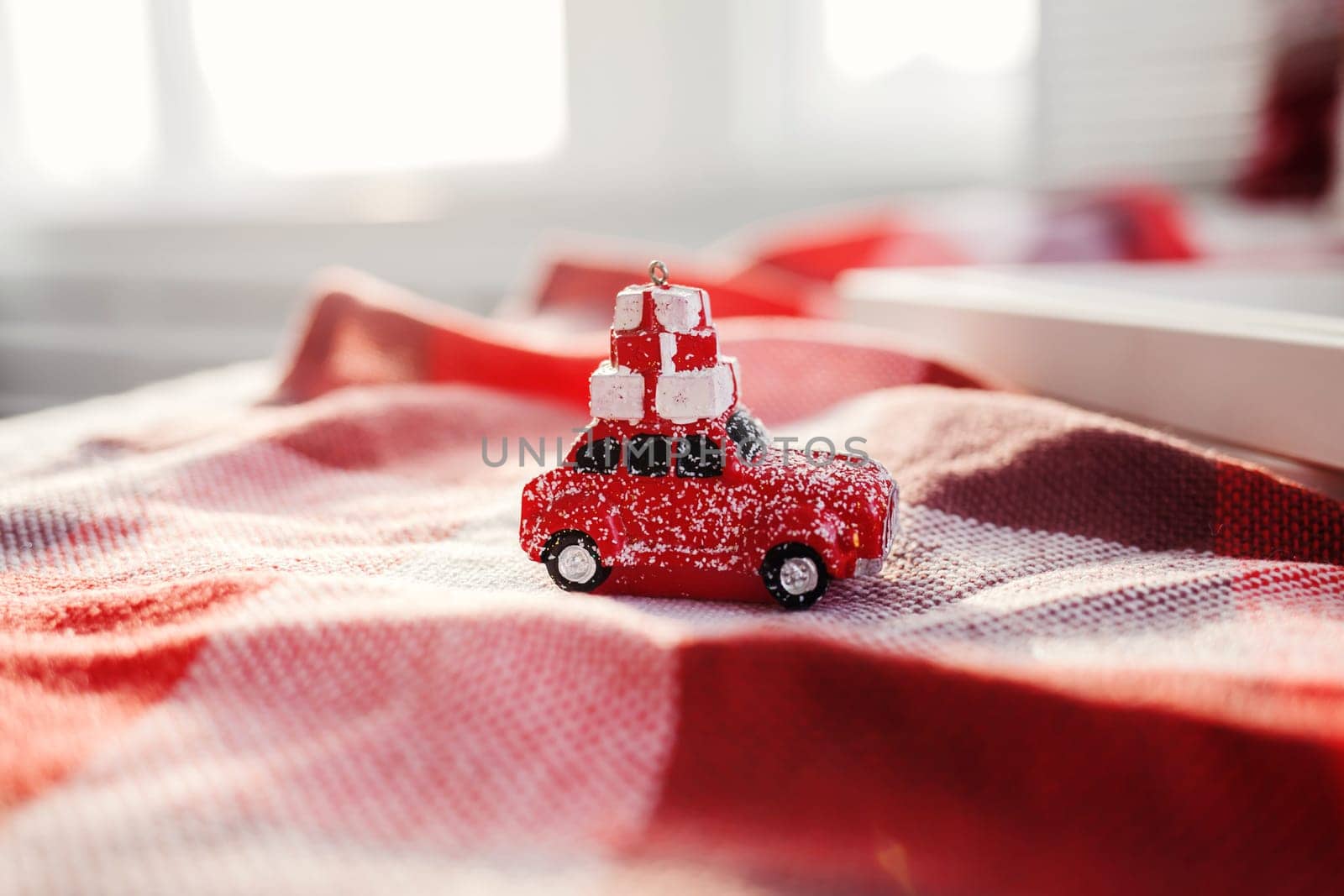 Red retro toy car delivering Christmas or New Year gifts